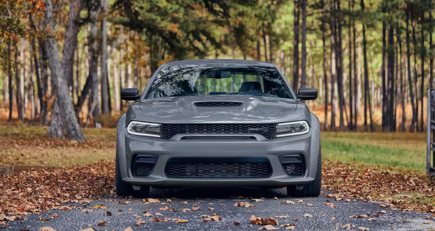 A gray charger sitting parked.