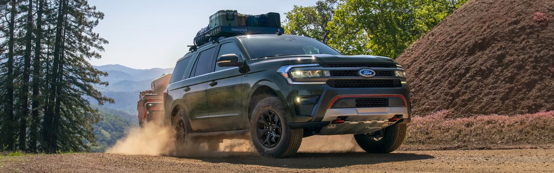 A black suv sitting in the road.