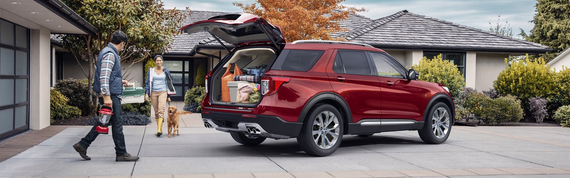 A woman walking to the back of a ford explorer.