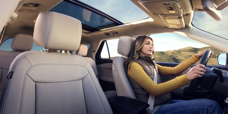 A woman driving a ford explorer.
