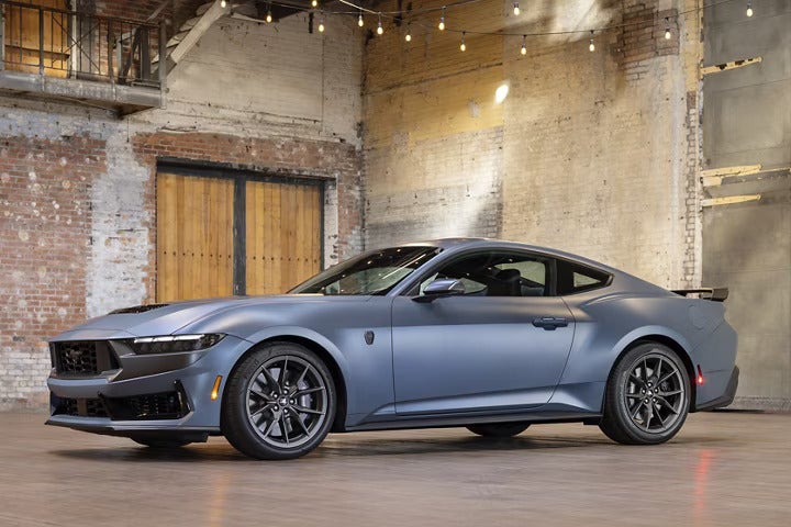 A blue mustang parked indoors.