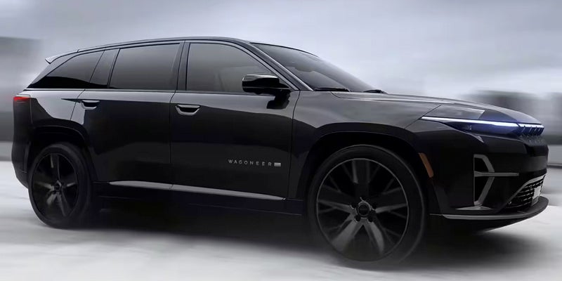 A black wagoneer s on the road.