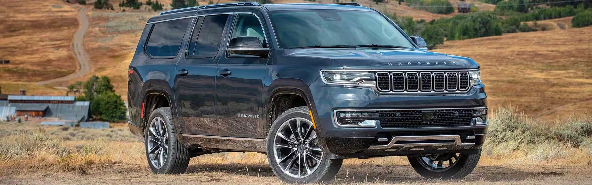 A gray suv pulling a trailer.