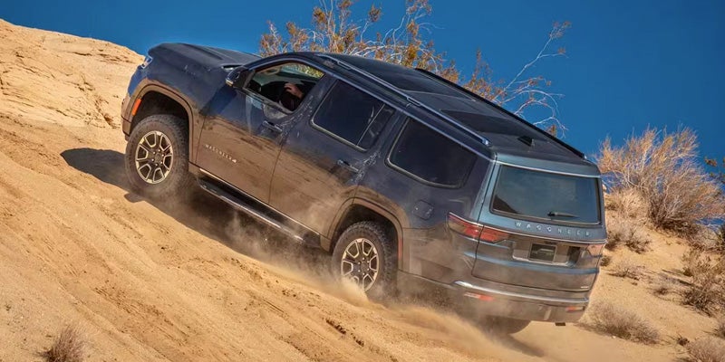 A suv driving up a hill.