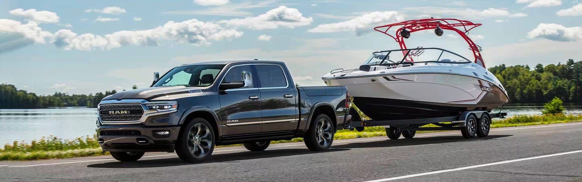 A silver truck pulling a boat.