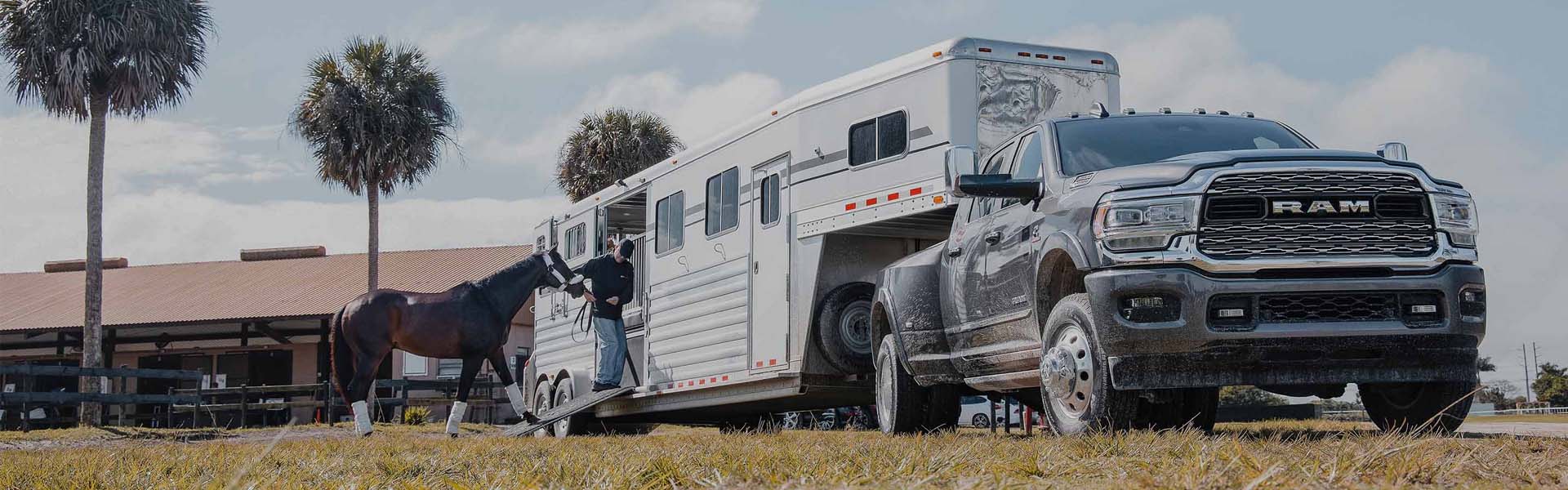 A white truck pulling a trailer.