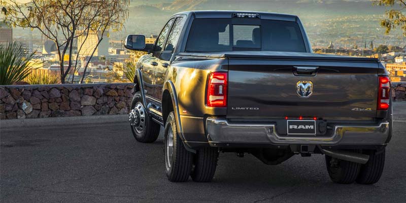 A silver ram truck sitting parked.