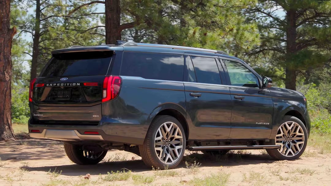 A navy suv sitting parked.
