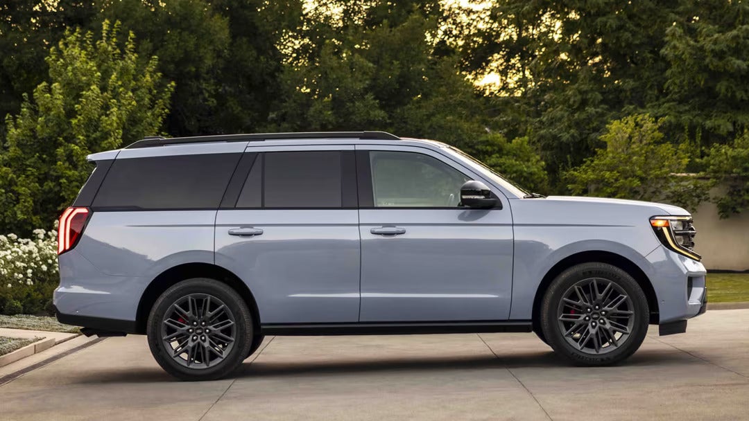 A gray suv sitting parked.