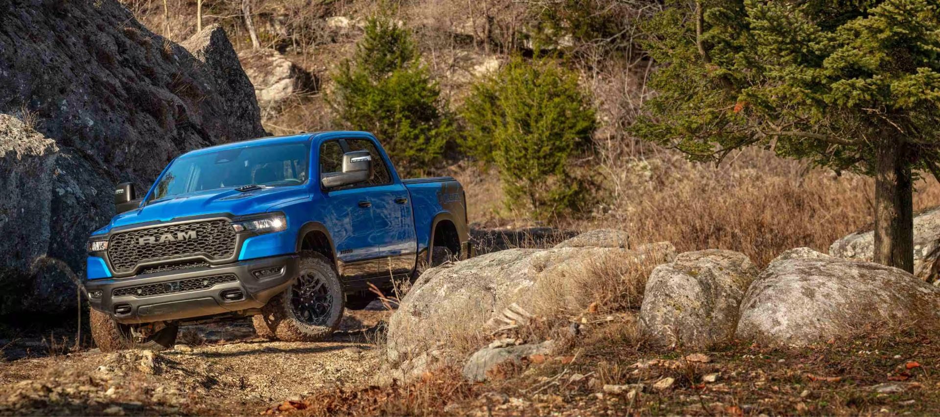 A blue ram 1500 driving off road.