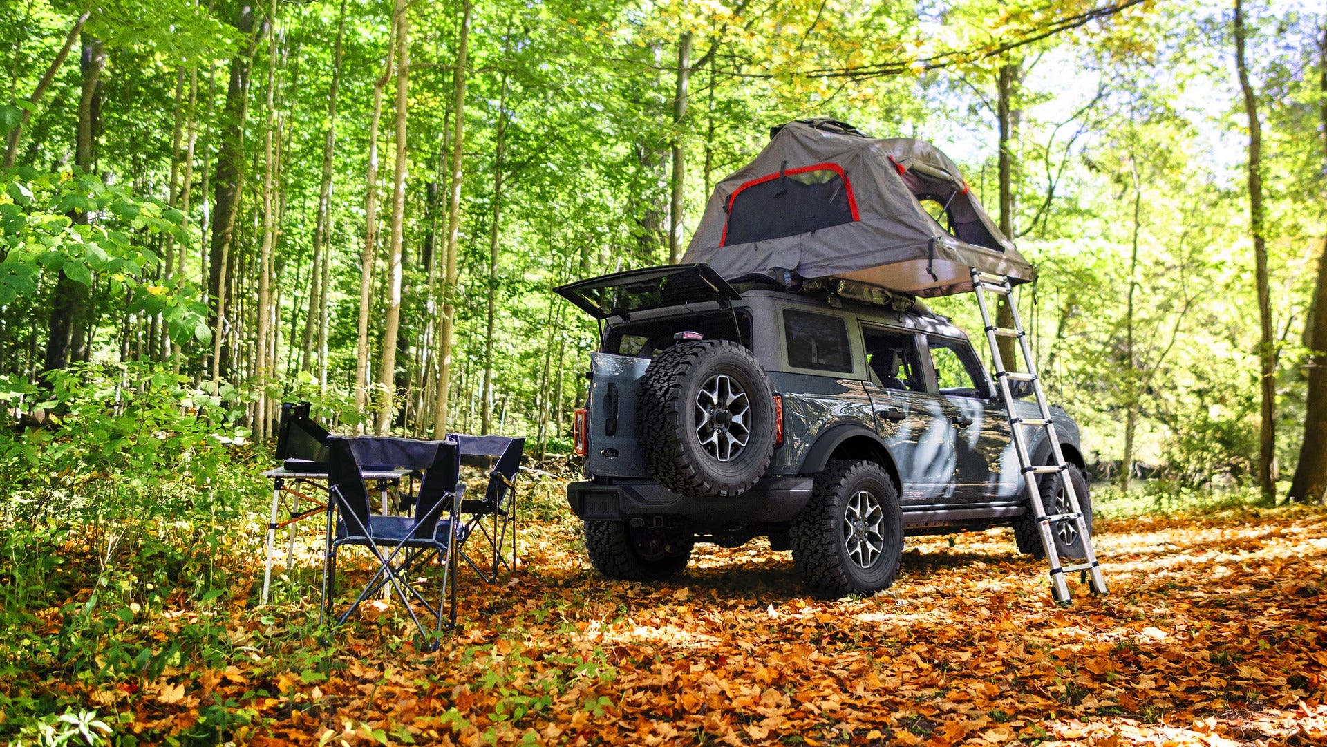 A bronco with a tent setup on it.