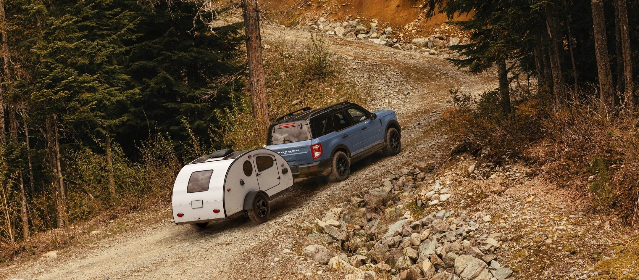 A bronco sport pulling a trailer.