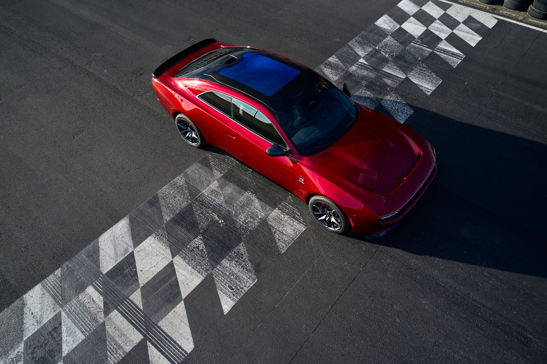 A red car sitting parked on a track.