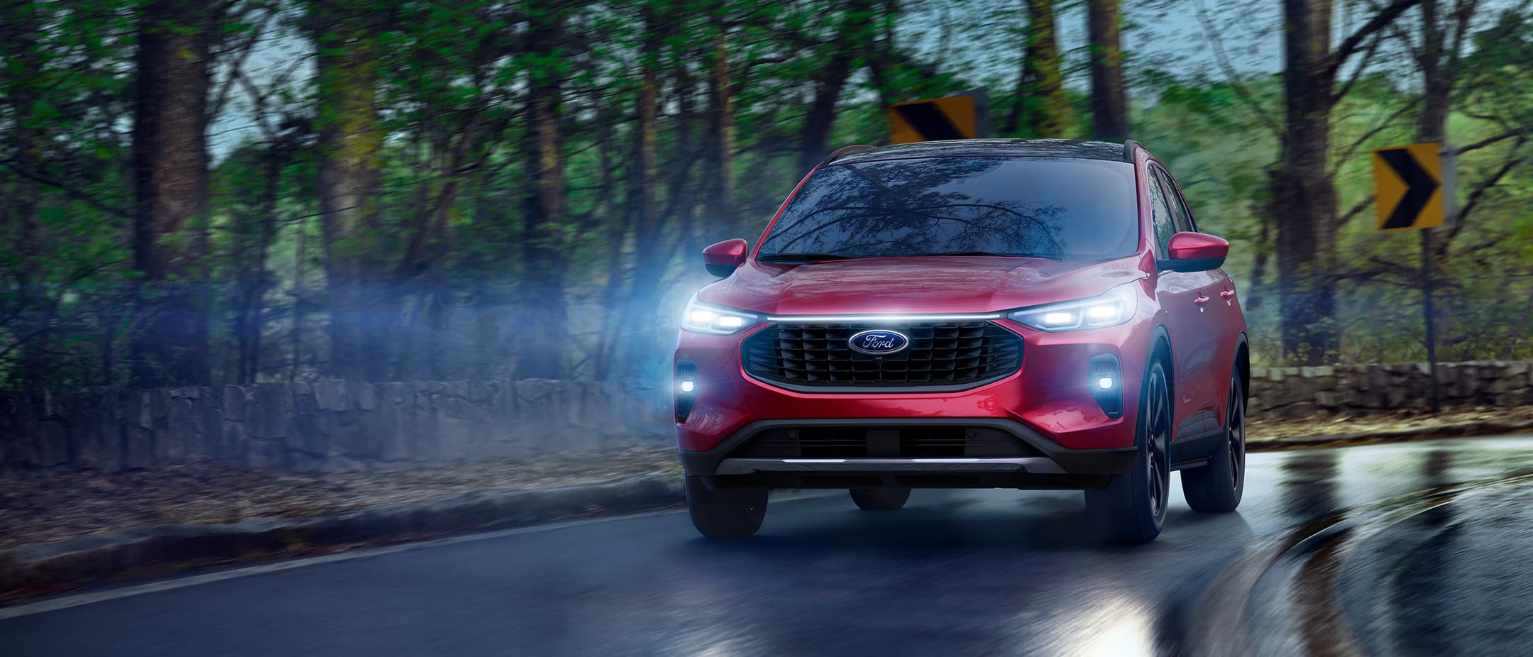 A red car driving on the road.