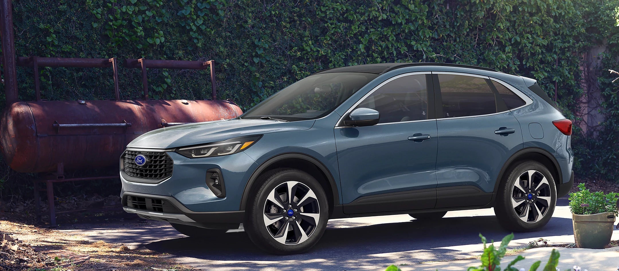 A blue car suv sitting parked.