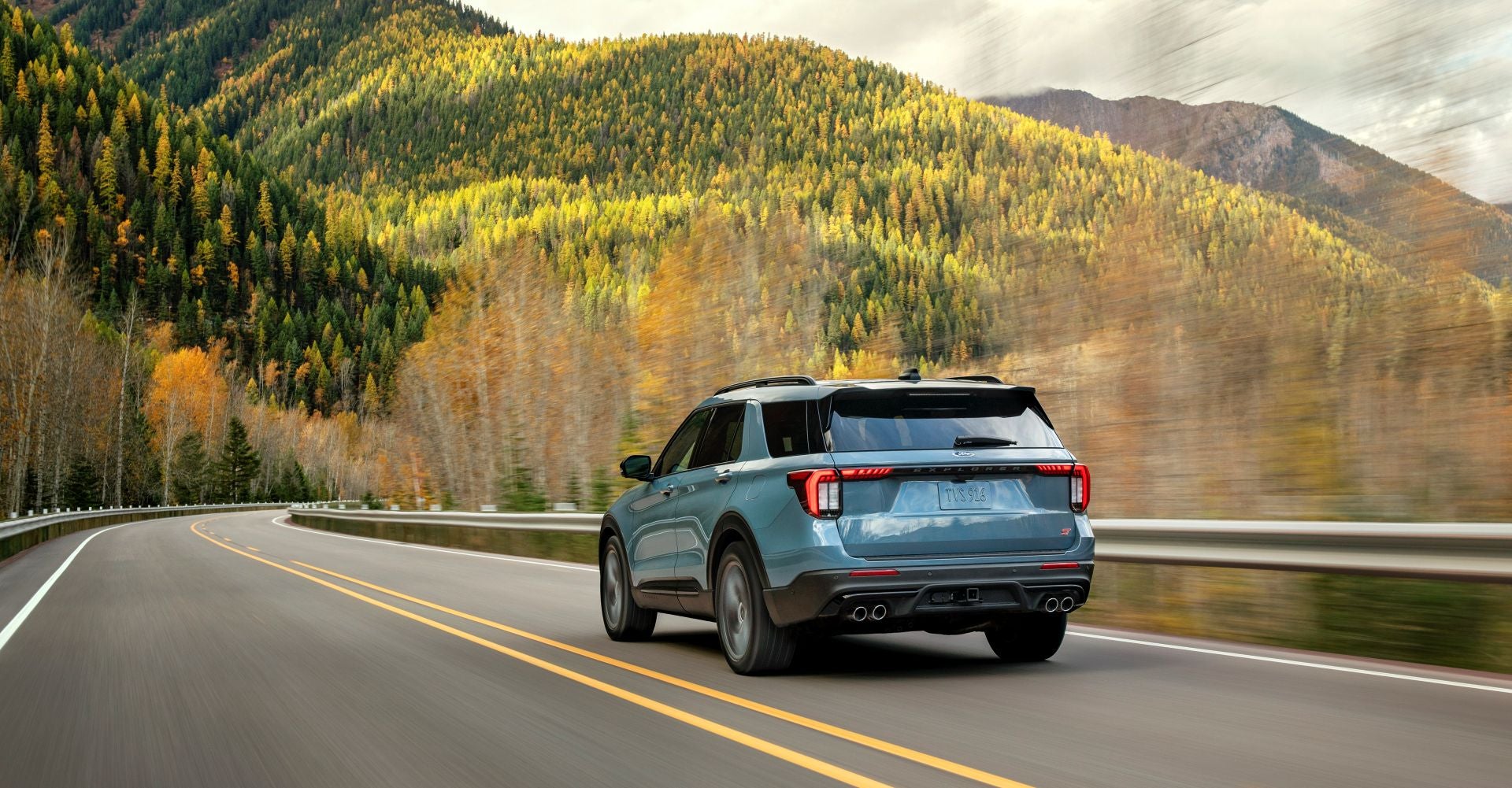 A ford explorer driving on a road.