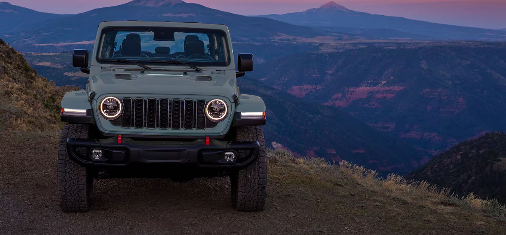 A gray jeep sitting parked.
