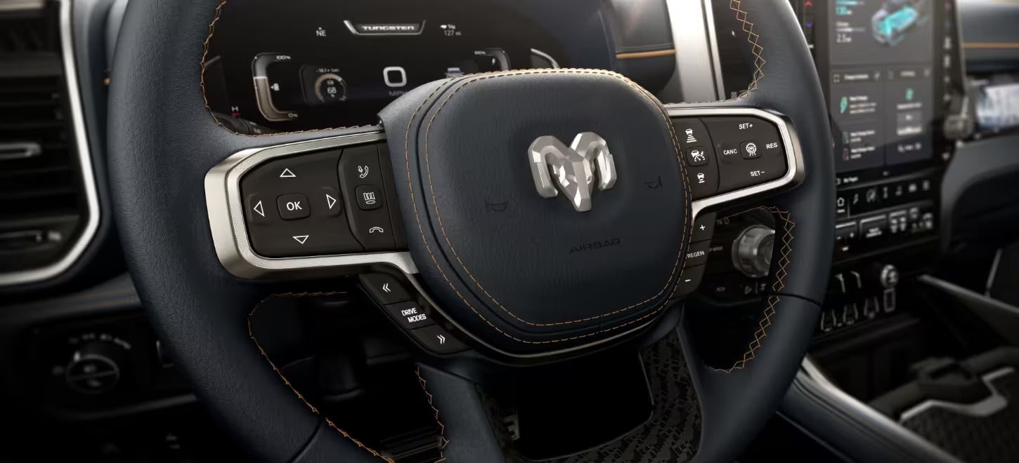 a close up of the steering wheel on a 2025 ram 1500 rev