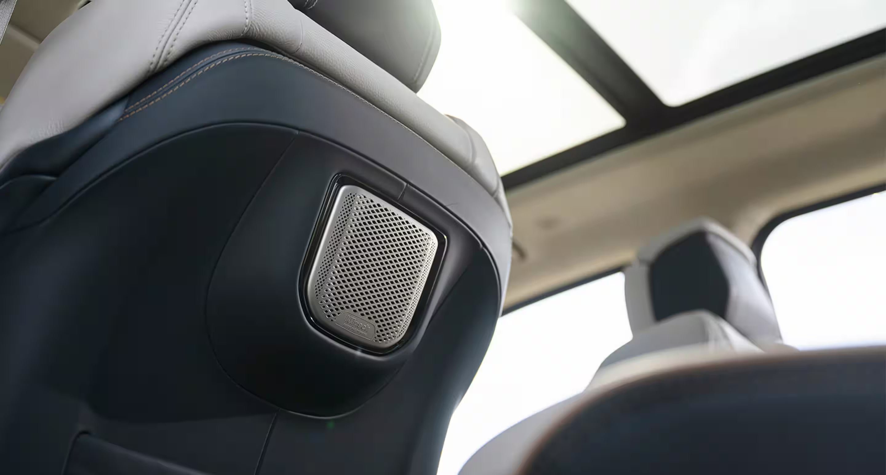 close up of a speaker on the back of the driver's seat in the 2025 ram 1500 rev