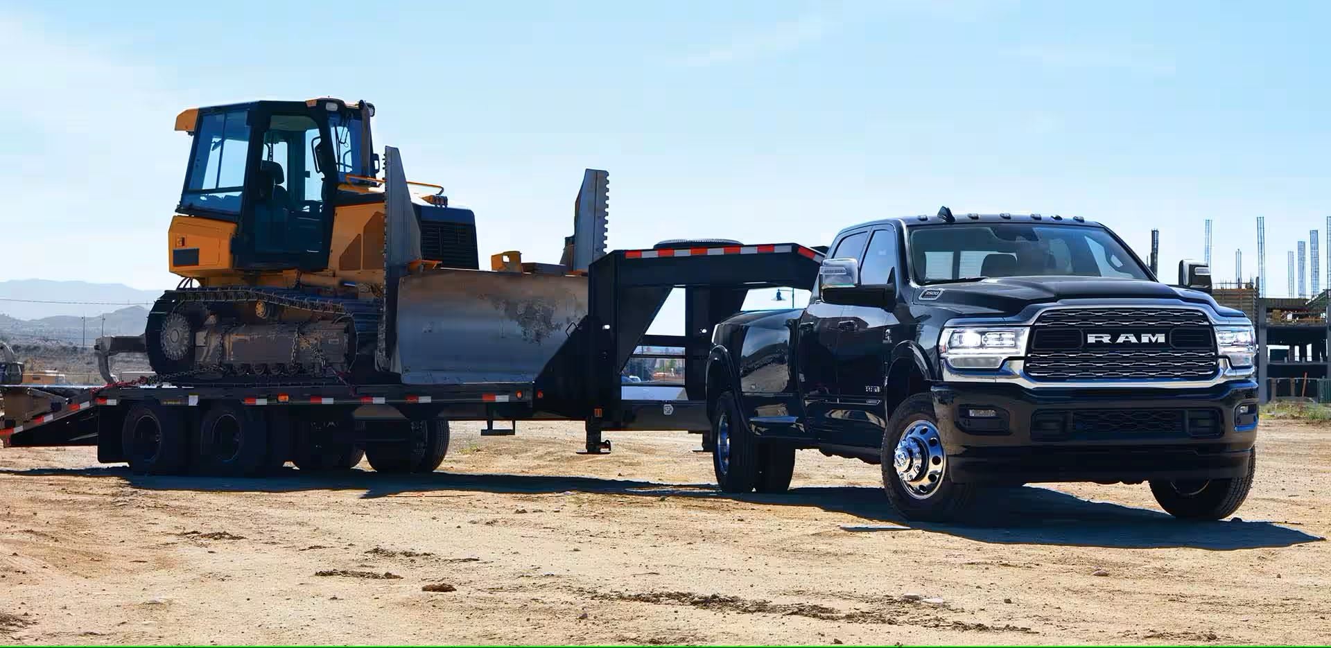 A black truck parked with a trailer.