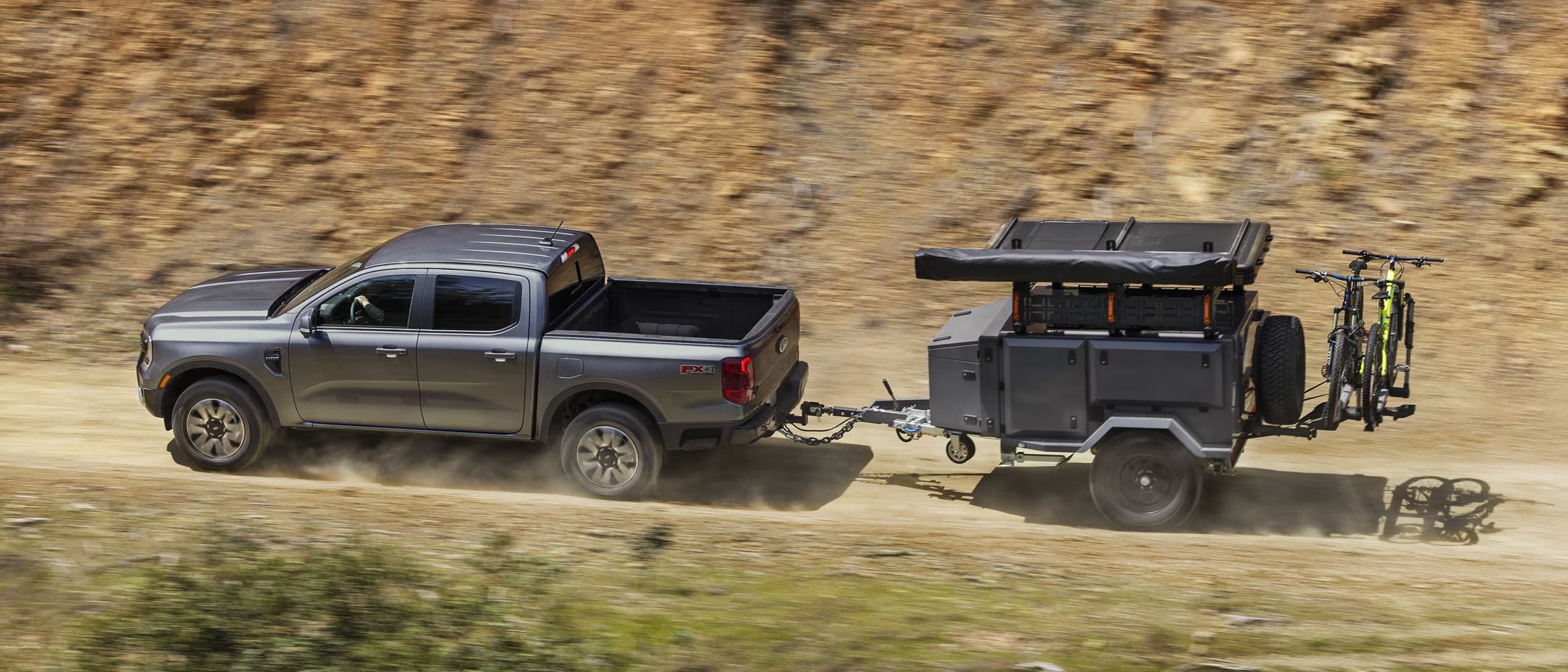 A silver truck pullinga trailer.