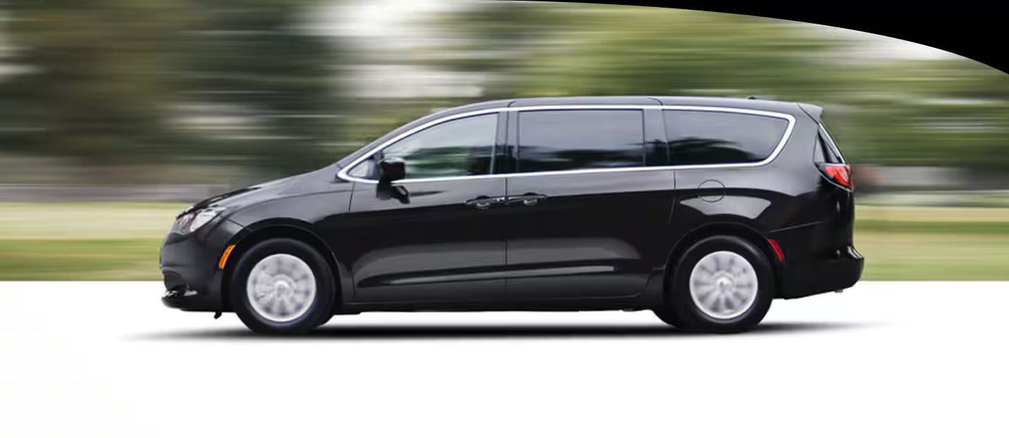 A black van driving on the road.