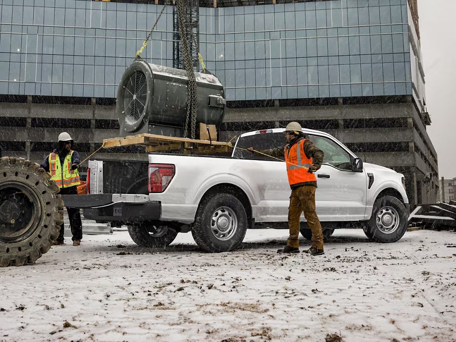Construction men loading a Ford F-150.