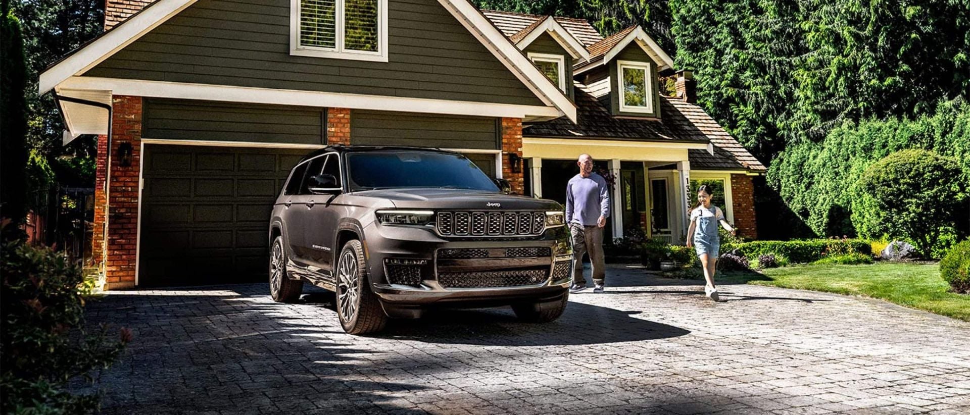 A grand cherokee parked in a driveway.