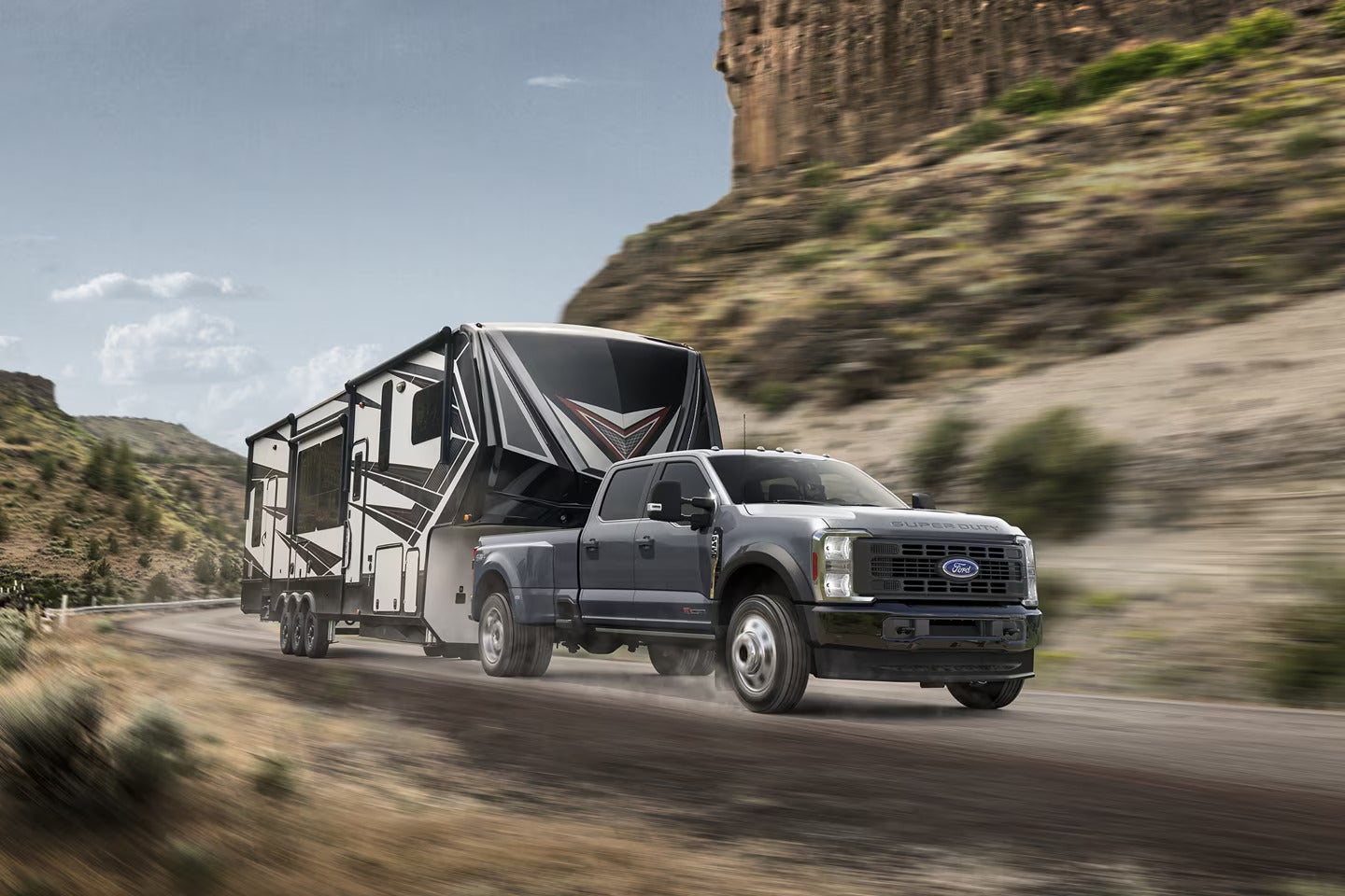 A black truck driving on the road.