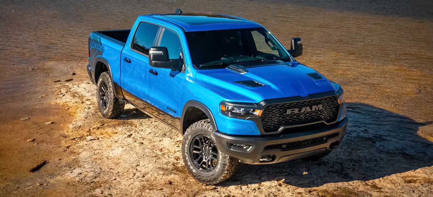 A blue truck sitting parked.