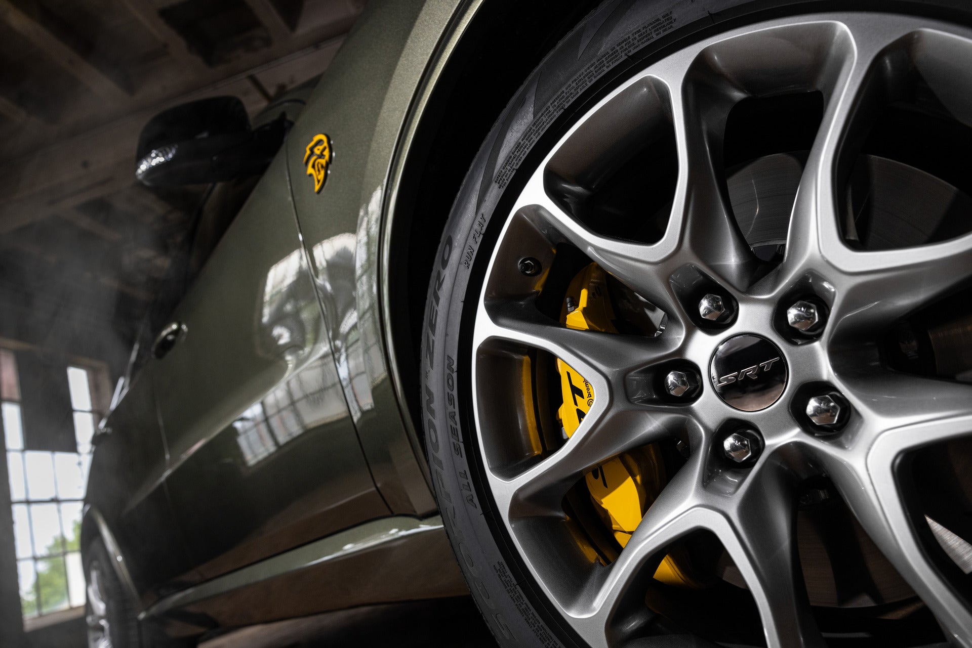 an upwards exterior view of the rims and tires and the side of the vehicle