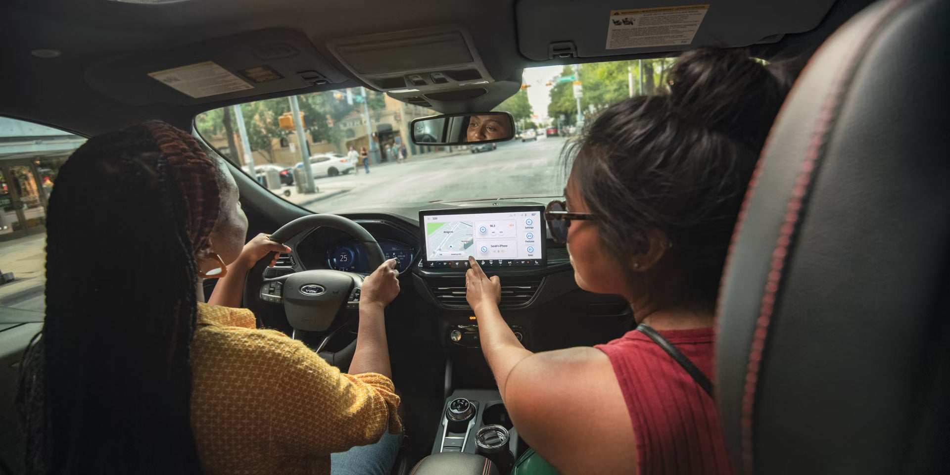 2026 Ford Escape view of a passenger using the infotainment system
