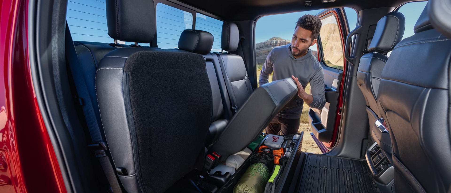 2026 Ford F-150 Interior view of a man pushing up the back seats