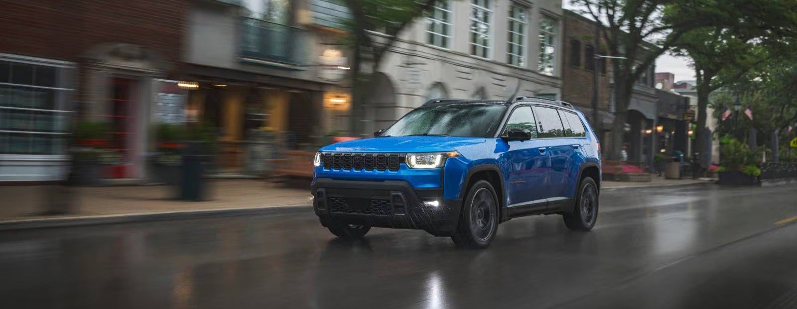 a new 2026 jeep cherokee driving in the city