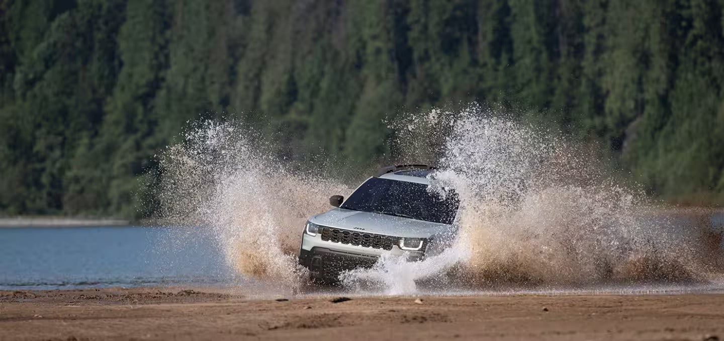 2026 Jeep Cherokee driving in a creek
