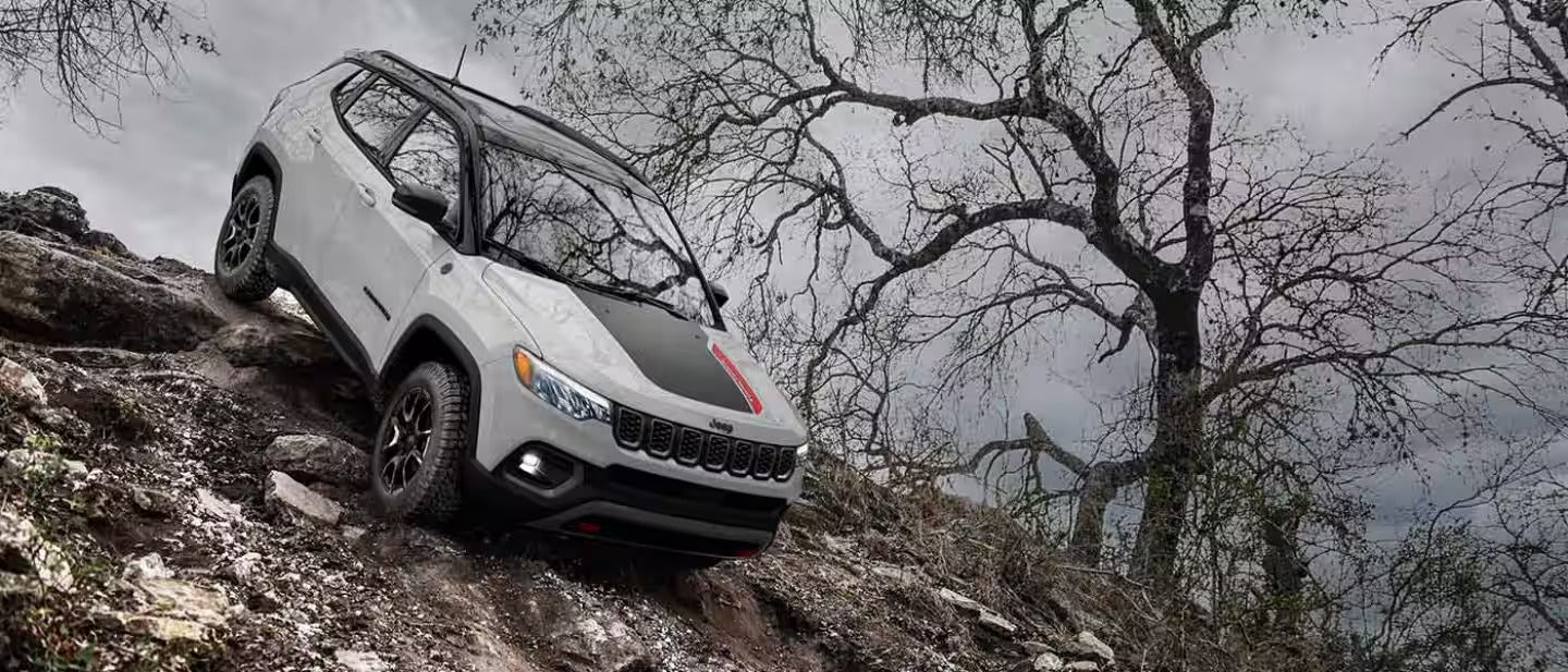 2026 Jeep Compass driving down the side of a mountain