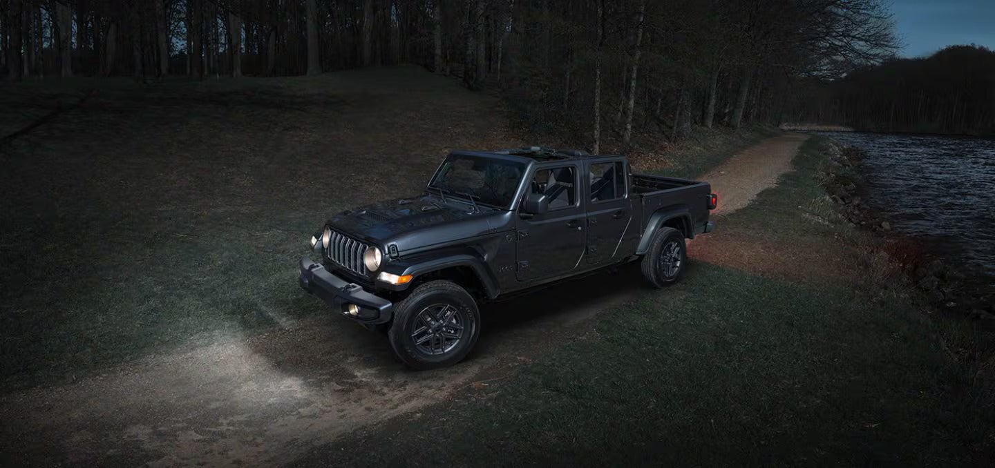 2026 Jeep Gladiator driving down a road at night