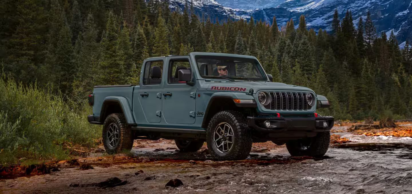 2026 Jeep Gladiator parked on some rocks in the forest
