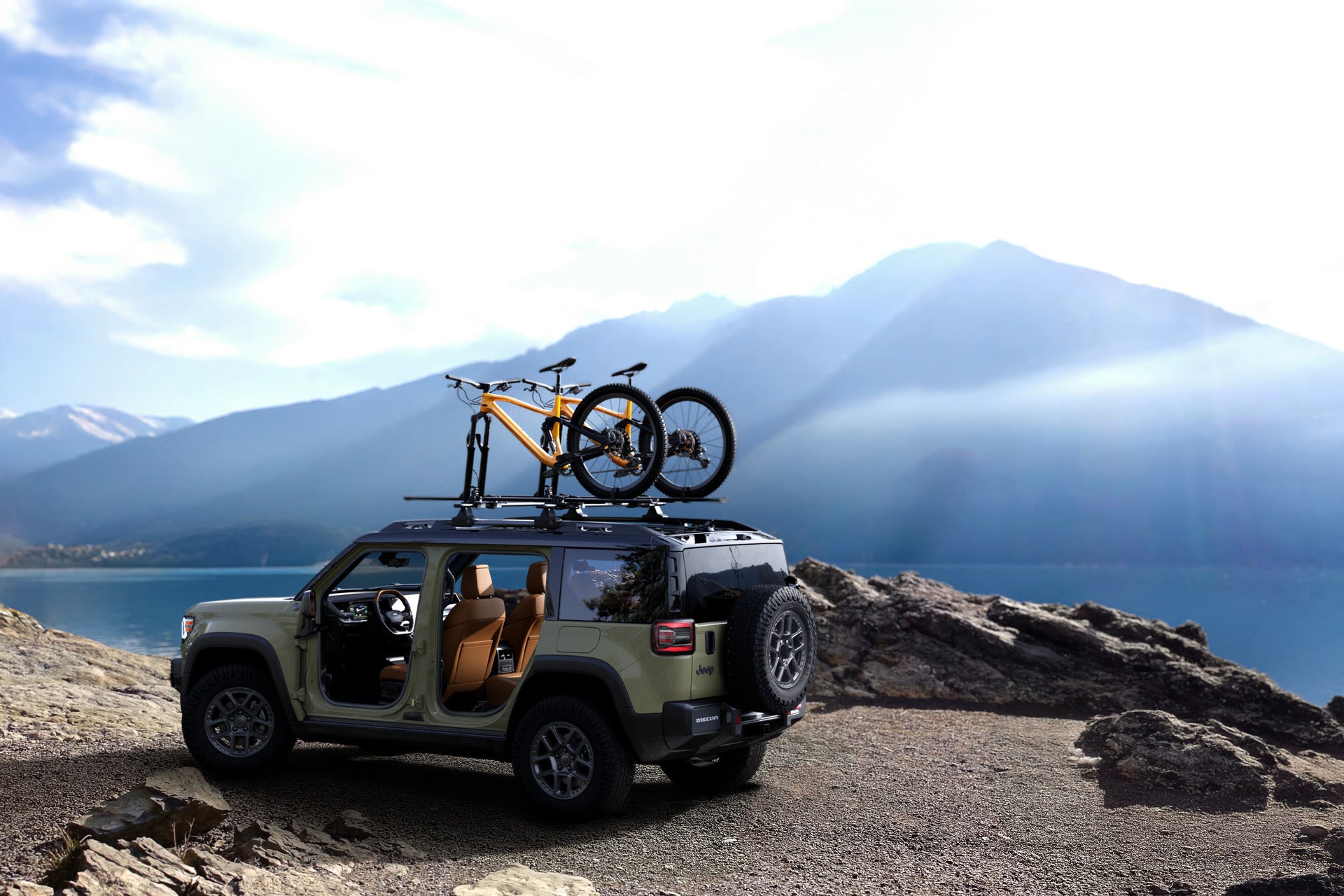 2026 Jeep Recon parked in the mountains with two mountain bikes on the roof rack