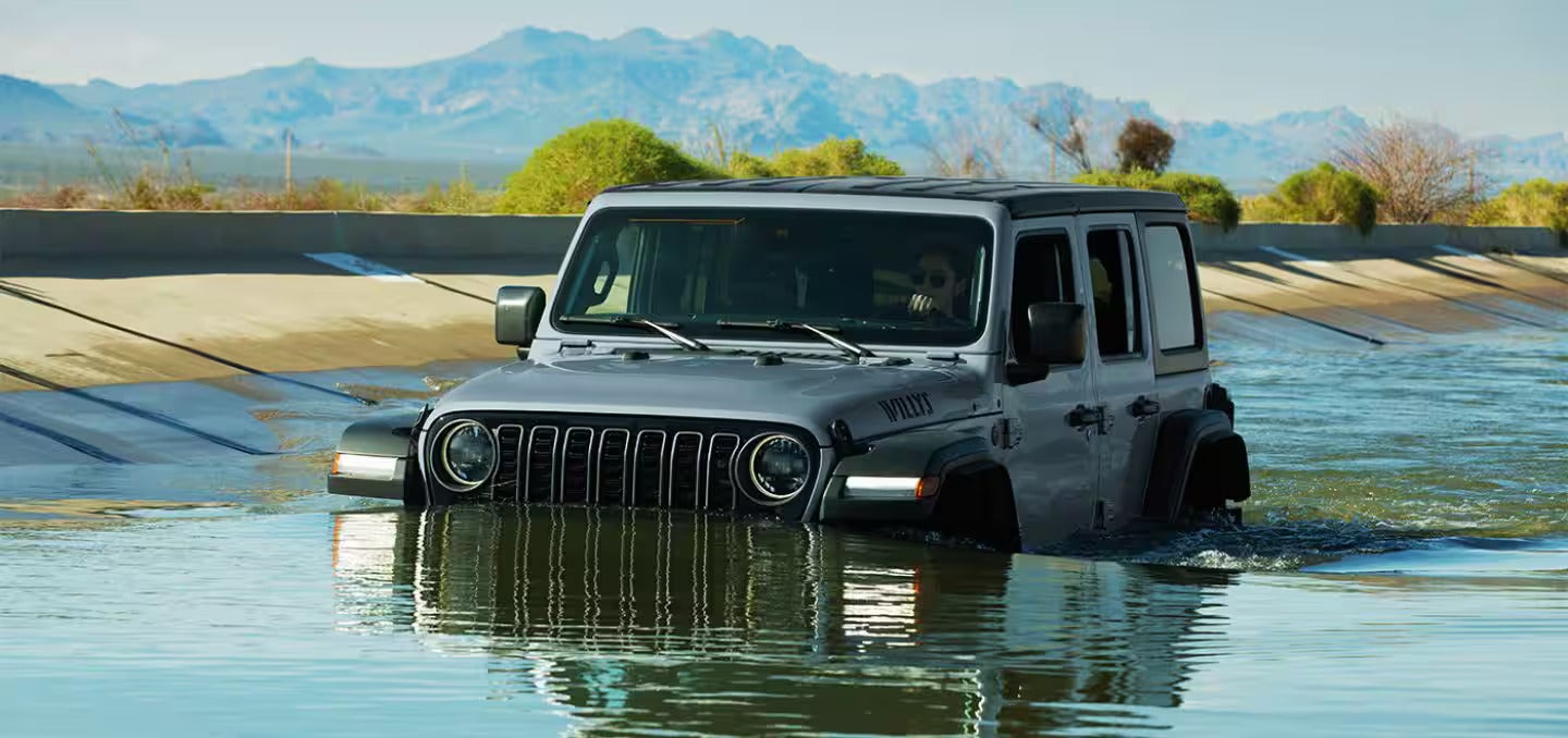 2026 Jeep Wrangler driving in a river