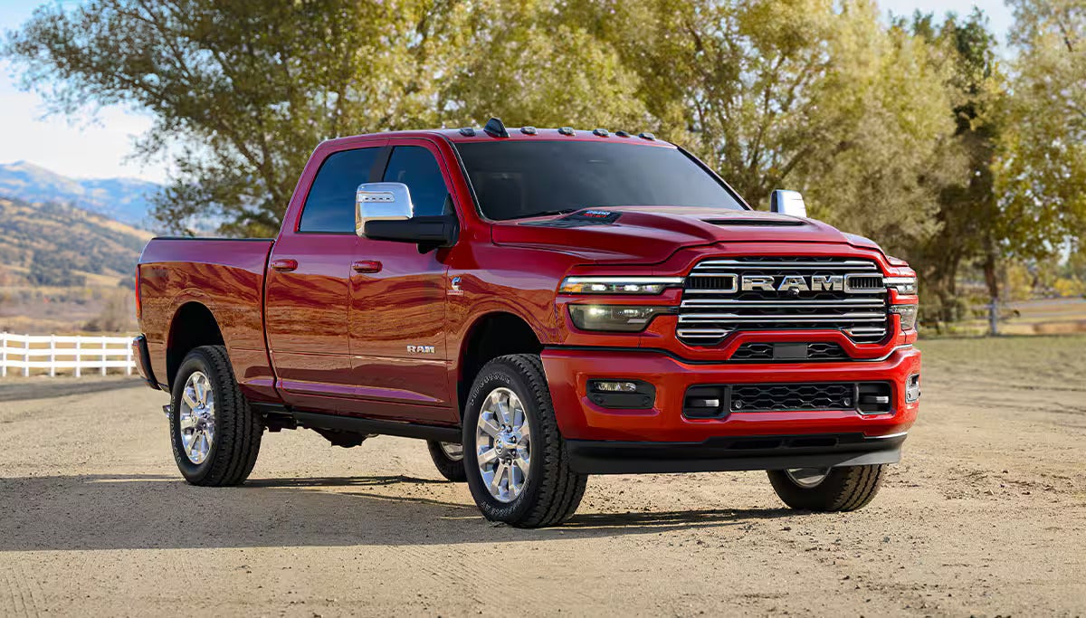 a red 2026 Ram 2500 parked on a dirt road