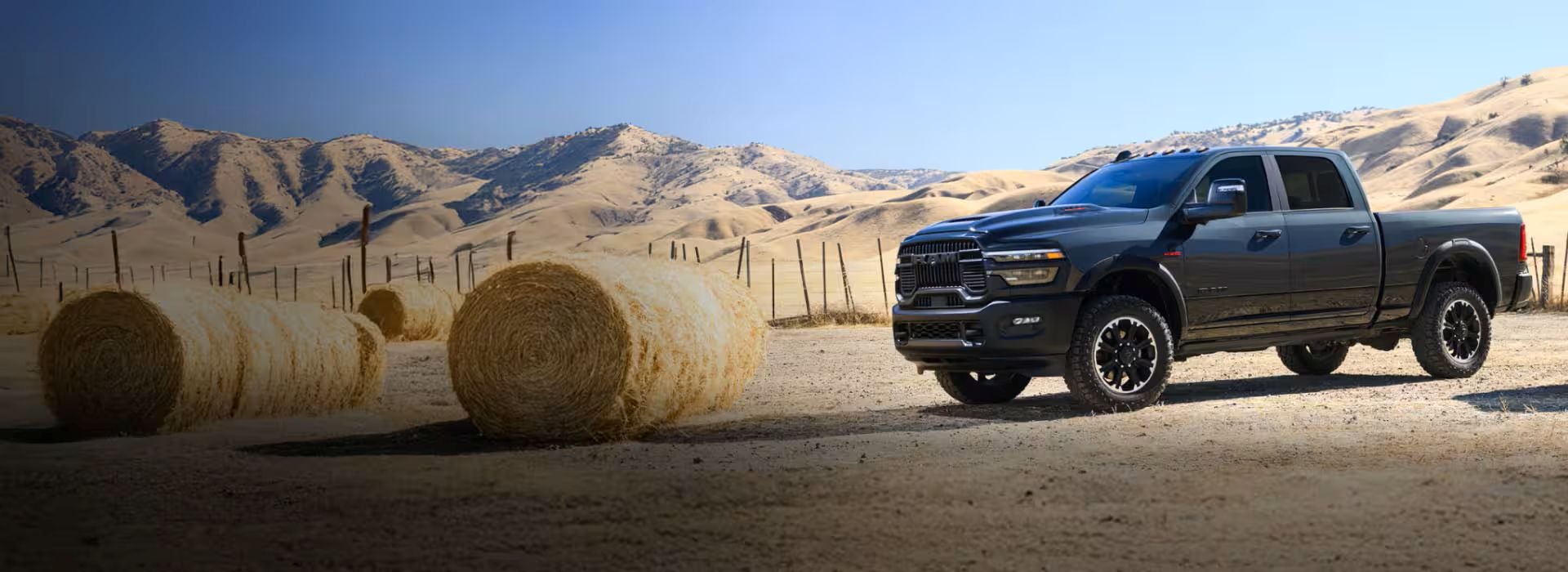 a red 2026 Ram 2500 parked on a dirt road