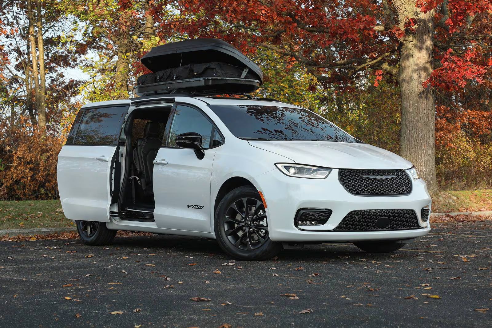 A white van parked with the door open.