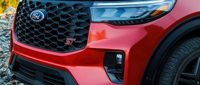 up close view of a red escape with the ST badging on the front grille