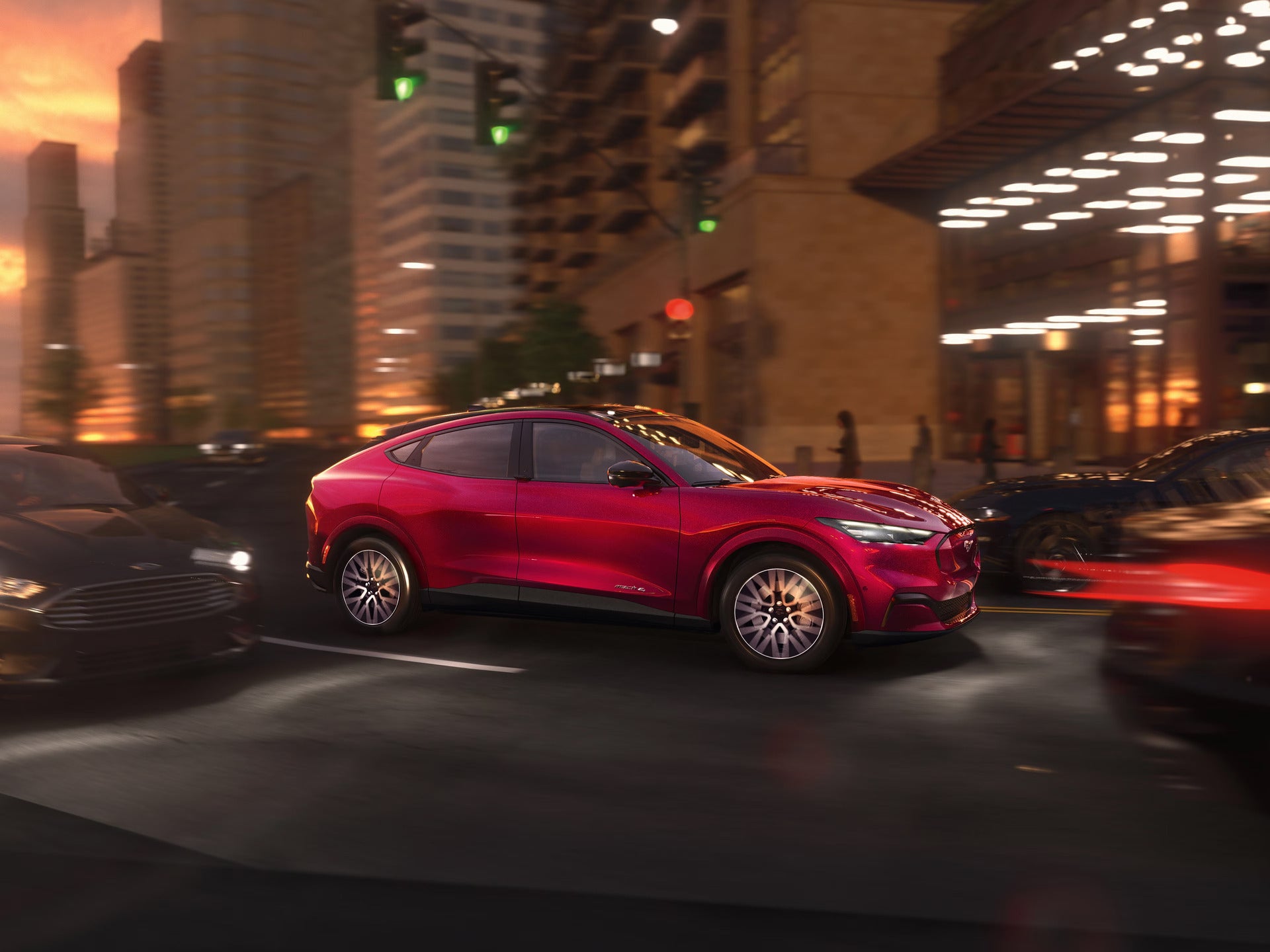 a red ford mustang mach-e driving in the city at night