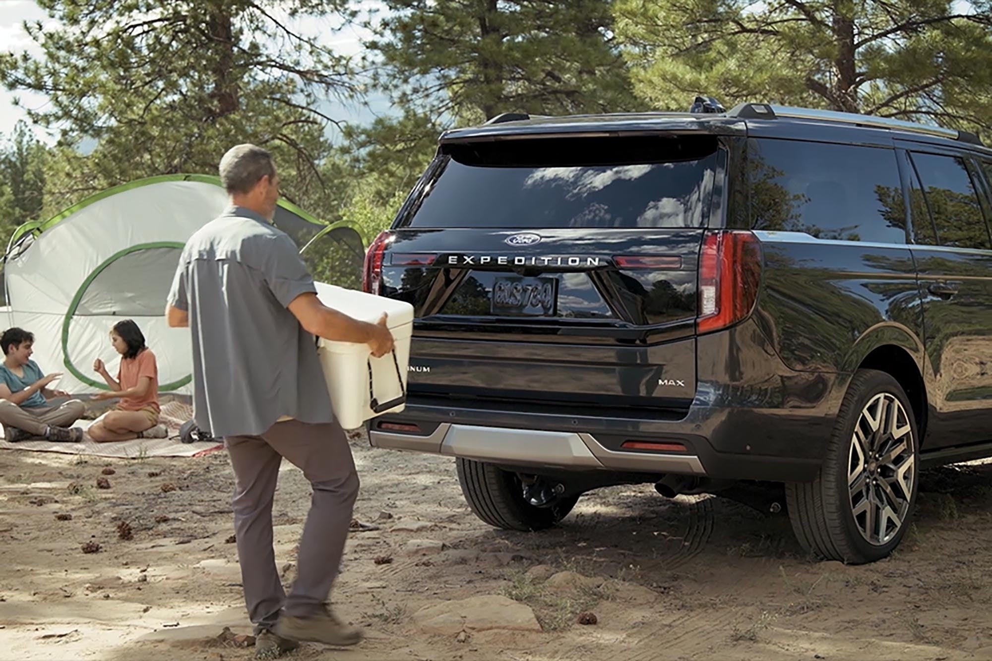 Person using the split gate on a 2026 Ford Expedition to load a cooler